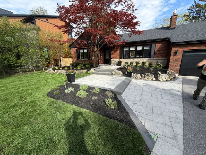 Planted bed running alongside the existing paver walkway to the front landing.