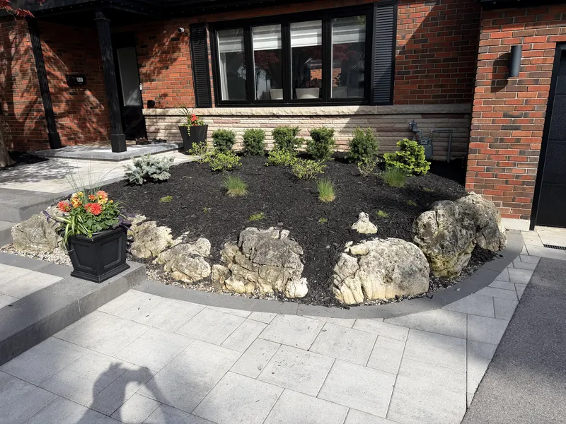 Detail of the paver landing meeting the planted bed and lawn edge.